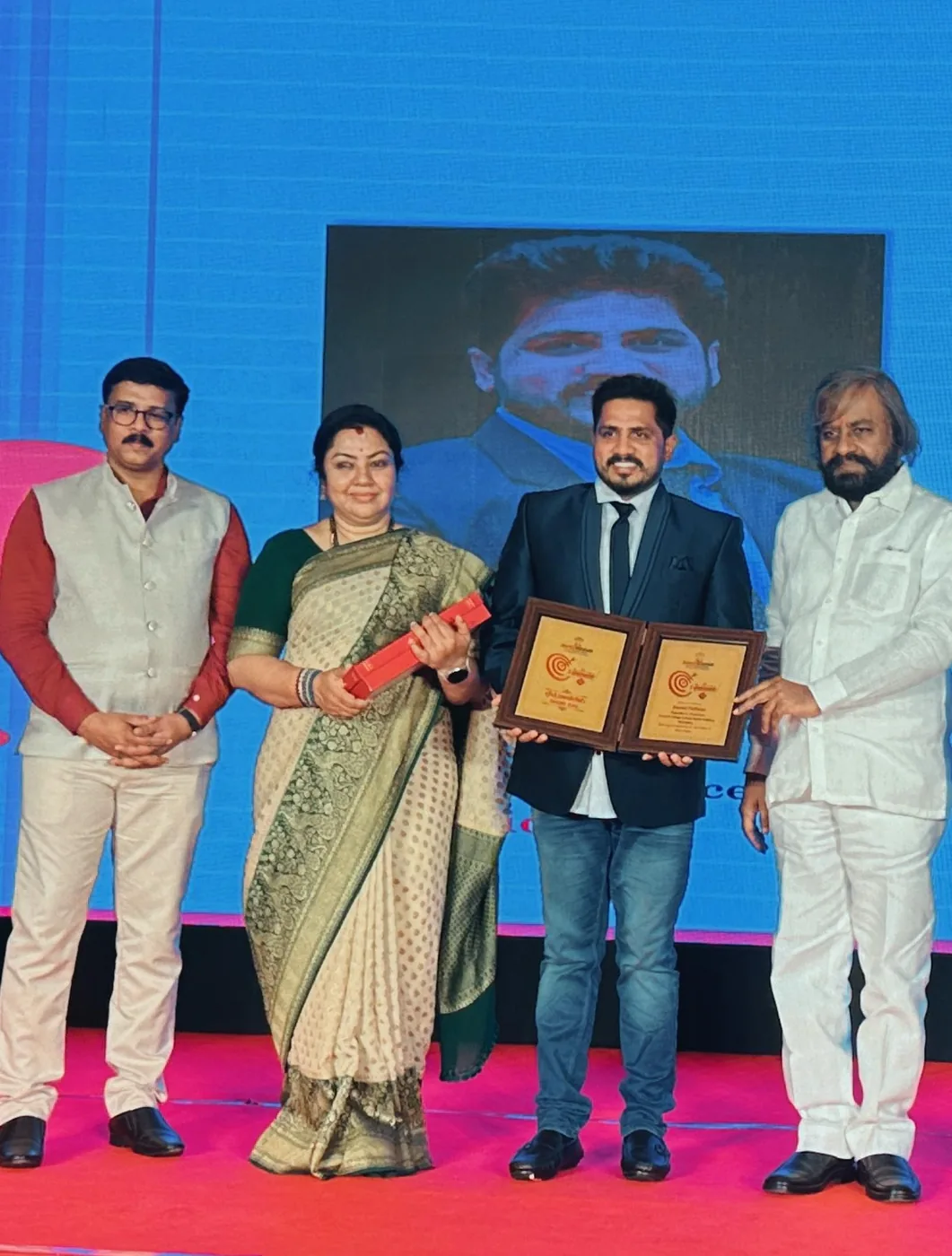 Mr. Anand Pothina receiving the State Award – Achievers of Karnataka on stage